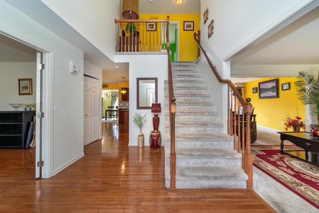 5992 Cedar Ridge Dr, Ann Arbor, MI 48103 - staircase with a high ceiling and wood finished floors