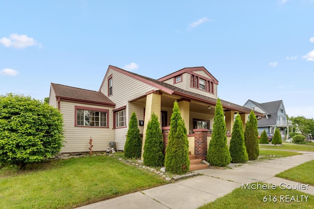 626 Academy St, Portland, MI 48875 - view of front of home with a front lawn and covered porch