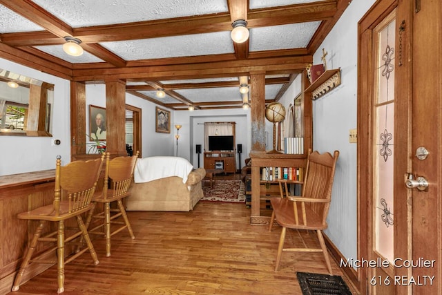 626 Academy St, Portland, MI 48875 - living room featuring coffered ceiling, wood finished floors, and beamed ceiling