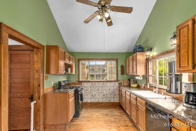 626 Academy St, Portland, MI 48875 - kitchen with gas range oven, black dishwasher, vaulted ceiling, light wood-style flooring, and ceiling fan