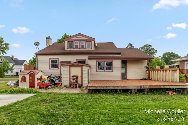 626 Academy St, Portland, MI 48875 - rear view of house with a deck, a yard, a chimney, and a shingled roof