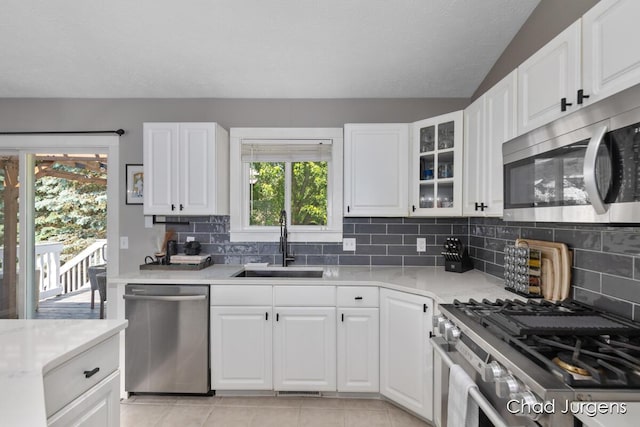 647 Maynard NW, Grand Rapids, MI 49504 - kitchen with stainless steel appliances, light countertops, decorative backsplash, and vaulted ceiling