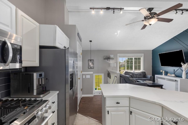 647 Maynard NW, Grand Rapids, MI 49504 - kitchen with appliances with stainless steel finishes, open floor plan, a ceiling fan, white cabinets, and vaulted ceiling