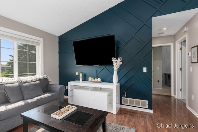 647 Maynard NW, Grand Rapids, MI 49504 - living room featuring dark wood-style floors, a decorative wall, and lofted ceiling