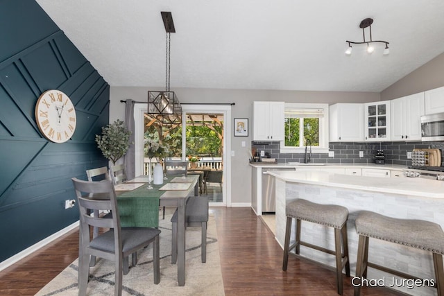 647 Maynard NW, Grand Rapids, MI 49504 - dining space featuring dark wood finished floors, vaulted ceiling, and a chandelier