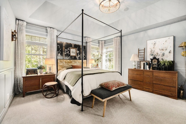 2975 Pine Edge Ct, Holland, MI 49424 - carpeted bedroom with multiple windows, a wainscoted wall, and a chandelier