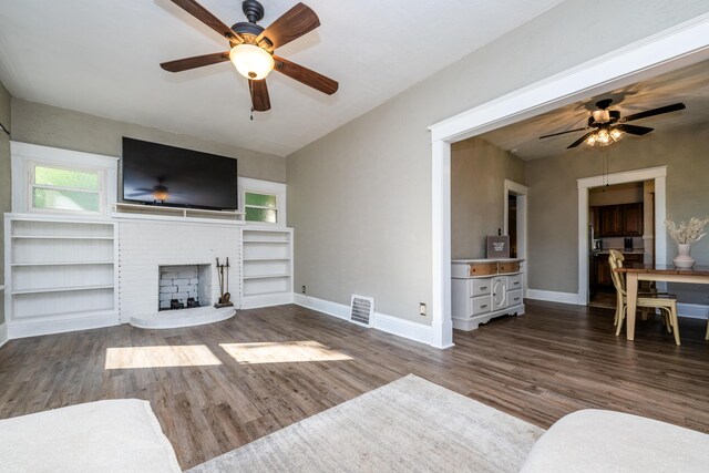620 Vann St, Niles, MI 49120 - unfurnished living room featuring a ceiling fan, wood finished floors, a brick fireplace, built in features, and lofted ceiling