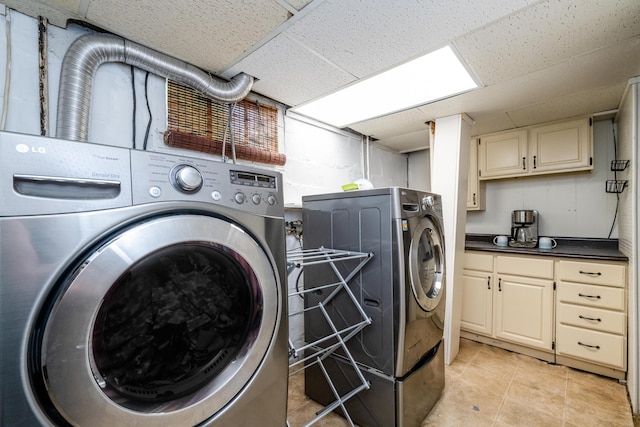 620 Vann St, Niles, MI 49120 - washroom with cabinet space, washer and dryer, and light tile patterned flooring