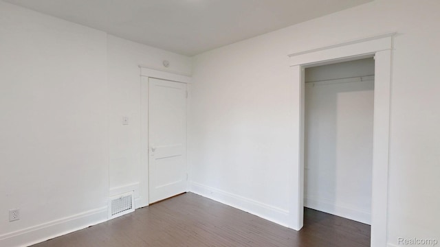 1906 N Charles St, Saginaw, MI 48602 - unfurnished bedroom featuring dark wood-type flooring
