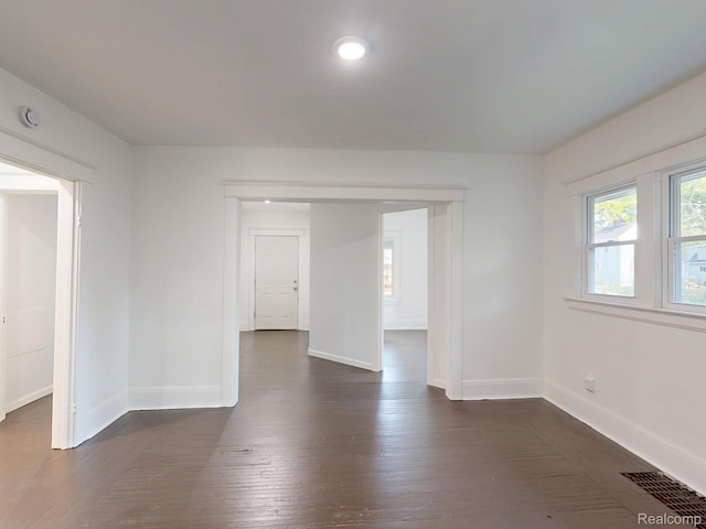 1906 N Charles St, Saginaw, MI 48602 - spare room with dark wood-type flooring and a smoke detector