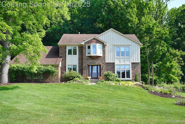 36780 Chesapeake Rd, Farmington Hills, MI 48335 - view of front of property with a front lawn, board and batten siding, and brick siding
