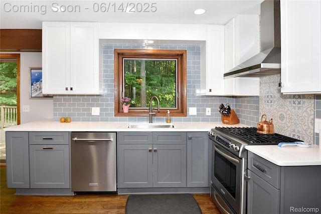 36780 Chesapeake Rd, Farmington Hills, MI 48335 - kitchen featuring wall chimney range hood, stainless steel appliances, gray cabinetry, and light countertops
