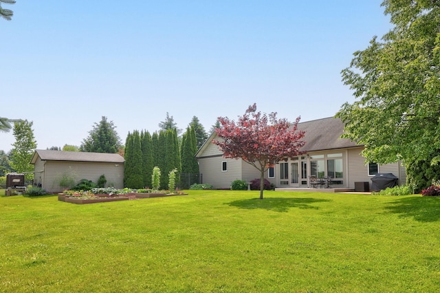 10317 Lange Rd, Birch Run, MI 48415 - view of green lawn with a garden