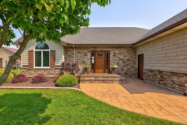 10317 Lange Rd, Birch Run, MI 48415 - property entrance featuring stone siding, roof with shingles, and a lawn
