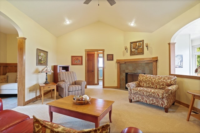 10317 Lange Rd, Birch Run, MI 48415 - living room featuring arched walkways, a ceiling fan, lofted ceiling, a tiled fireplace, and light carpet
