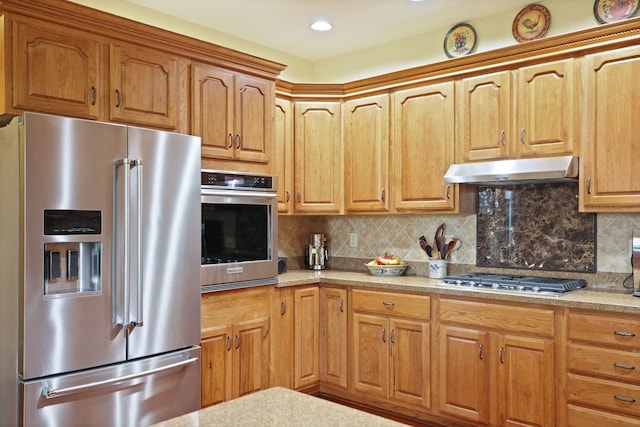 10317 Lange Rd, Birch Run, MI 48415 - kitchen featuring appliances with stainless steel finishes, under cabinet range hood, light countertops, tasteful backsplash, and recessed lighting