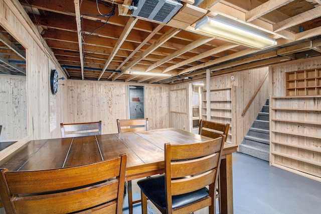 51591 Oak Dr, Mattawan, MI 49071 - unfurnished dining area featuring concrete floors, wooden walls, and stairway