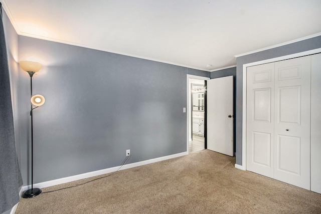 51591 Oak Dr, Mattawan, MI 49071 - unfurnished bedroom featuring carpet floors, crown molding, and a closet