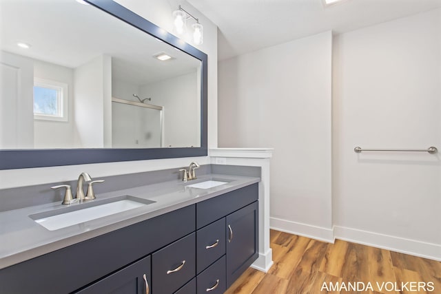 1753 Portadown Rd, Byron Center, MI 49315 - bathroom with double vanity, a shower with shower door, and wood finished floors