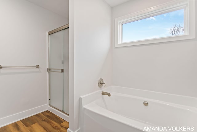 1753 Portadown Rd, Byron Center, MI 49315 - bathroom featuring a bath, a stall shower, and wood finished floors
