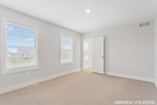 1753 Portadown Rd, Byron Center, MI 49315 - empty room with healthy amount of natural light and light carpet