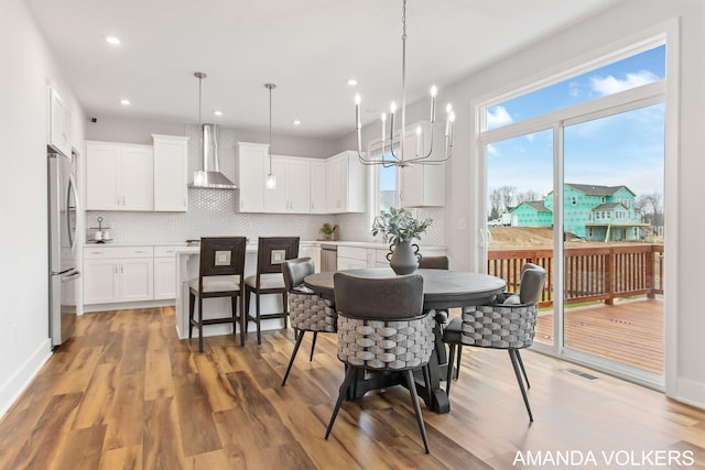 1753 Portadown Rd, Byron Center, MI 49315 - dining space featuring light wood-style flooring, a chandelier, and recessed lighting