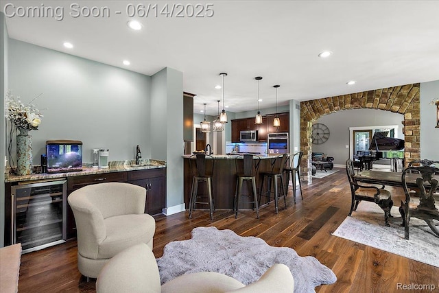 5432 Blood Rd, Metamora, MI 48455 - living room with beverage cooler, arched walkways, recessed lighting, dark wood-style flooring, and bar area