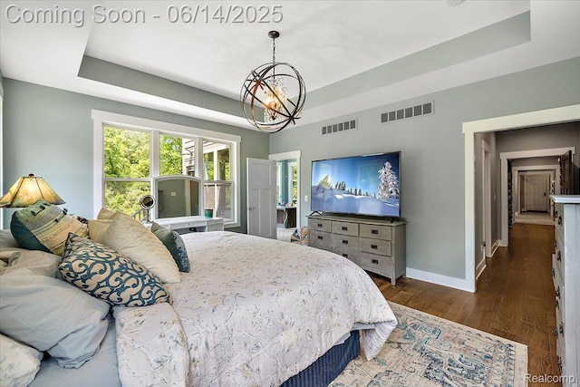 5432 Blood Rd, Metamora, MI 48455 - bedroom featuring a tray ceiling, a chandelier, and wood finished floors