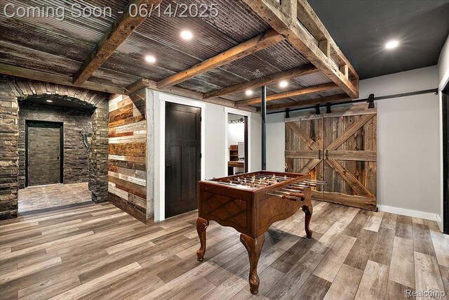 5432 Blood Rd, Metamora, MI 48455 - rec room with wood finished floors, a barn door, and a wooden ceiling with exposed beams