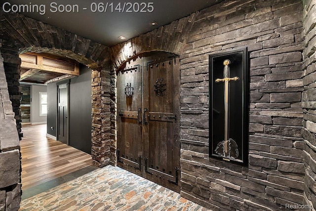 5432 Blood Rd, Metamora, MI 48455 - wine area featuring arched walkways, wood finished floors, and ornate columns