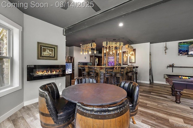 5432 Blood Rd, Metamora, MI 48455 - dining space with a bar, wood finished floors, a glass covered fireplace, and billiards