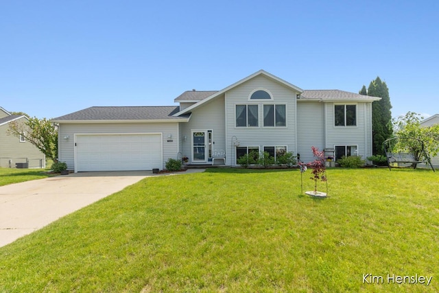 7088 Quintara Dr NE, Comstock Park, MI 49321 - tri-level home with a garage, driveway, and a front lawn