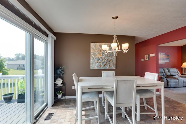 7088 Quintara Dr NE, Comstock Park, MI 49321 - dining space with a chandelier and stone finish floors