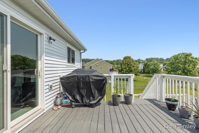 7088 Quintara Dr NE, Comstock Park, MI 49321 - wooden deck with a grill