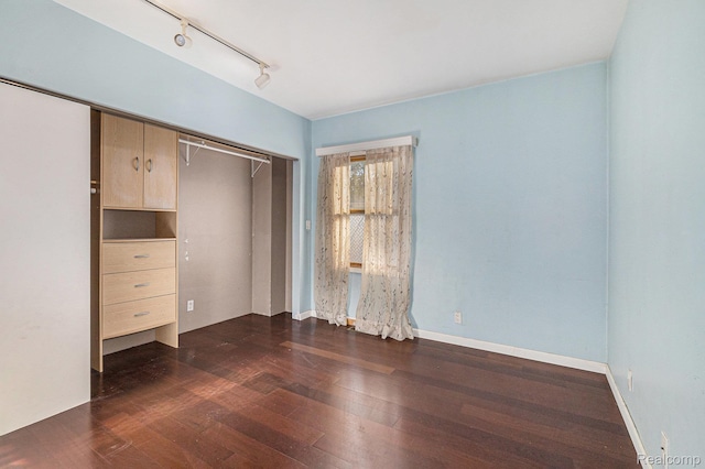 92 Gallup St, Mount Clemens, MI 48043 - unfurnished bedroom with dark wood-style floors, rail lighting, and a closet