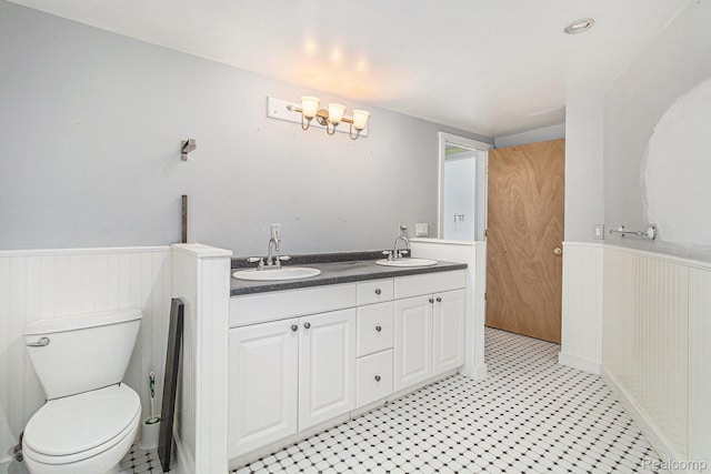 92 Gallup St, Mount Clemens, MI 48043 - full bath featuring a wainscoted wall, double vanity, and tile patterned floors