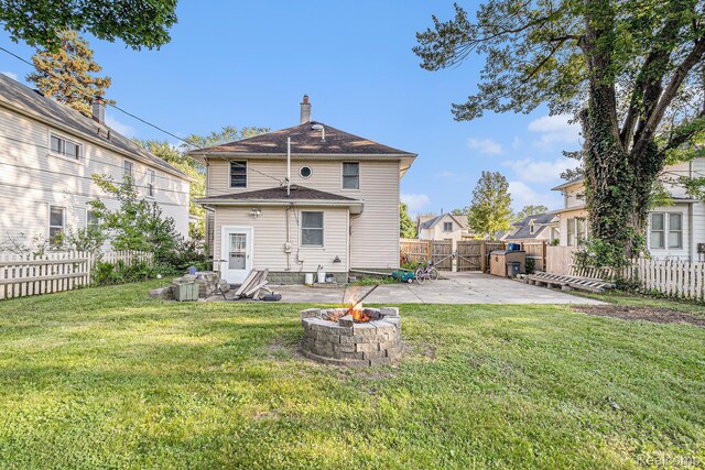 92 Gallup St, Mount Clemens, MI 48043 - back of property with a patio, a fenced backyard, a fire pit, and a chimney