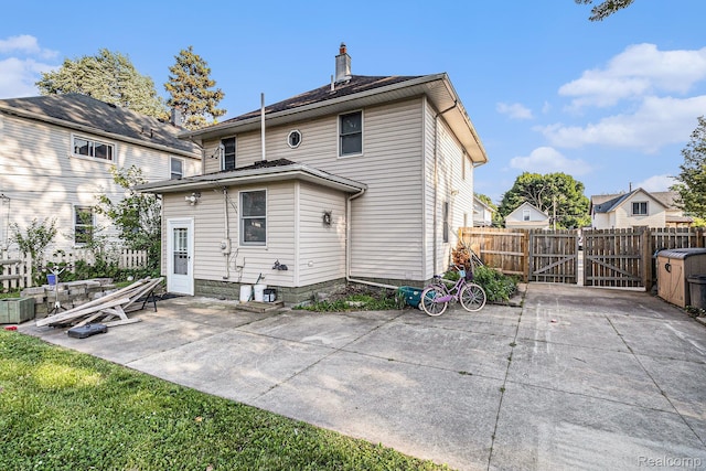 92 Gallup St, Mount Clemens, MI 48043 - back of house featuring a gate, a patio, and a chimney