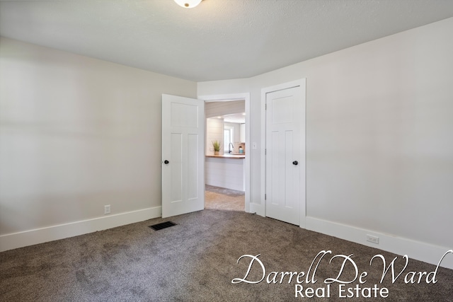 612 E Green St, Hastings, MI 49058 - carpeted empty room featuring a sink and baseboards