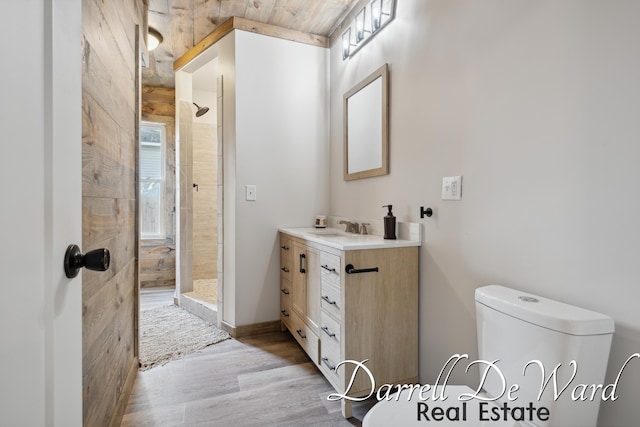 612 E Green St, Hastings, MI 49058 - bathroom featuring a tile shower, wood finished floors, and vanity
