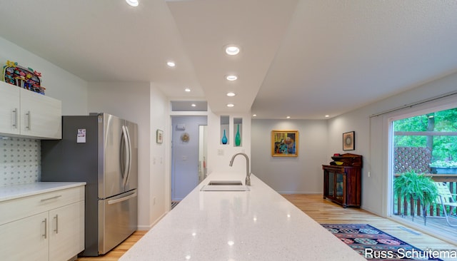 1366 W Norton Ave, Muskegon, MI 49441 - kitchen featuring freestanding refrigerator, light wood-style floors, recessed lighting, light stone counters, and decorative backsplash
