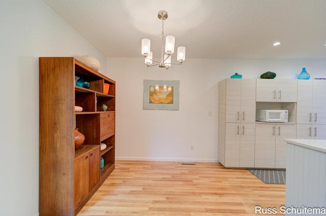 1366 W Norton Ave, Muskegon, MI 49441 - unfurnished dining area featuring light wood finished floors and a chandelier