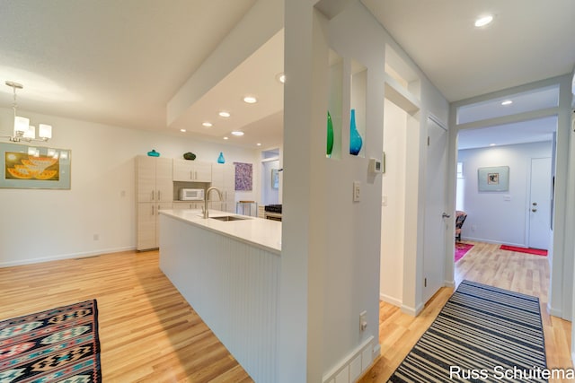 1366 W Norton Ave, Muskegon, MI 49441 - hall with light wood-type flooring, a chandelier, and recessed lighting