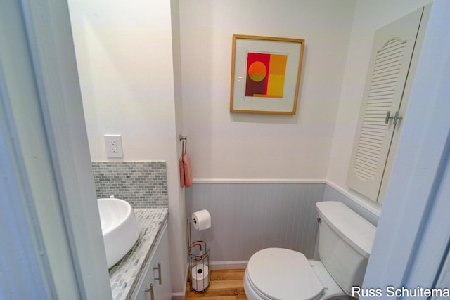 1366 W Norton Ave, Muskegon, MI 49441 - half bath featuring vanity, wainscoting, and wood finished floors