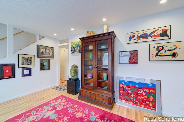 1366 W Norton Ave, Muskegon, MI 49441 - sitting room with wood finished floors, recessed lighting, and stairway