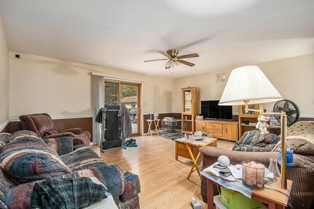 8887 Elm Valley Rd, Union Pier, MI 49129 - living area featuring light wood-type flooring, a ceiling fan, and a wainscoted wall