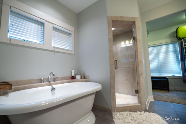 14921 Creek Edge Dr, Holland, MI 49424 - bathroom featuring tile patterned flooring, a soaking tub, and a stall shower