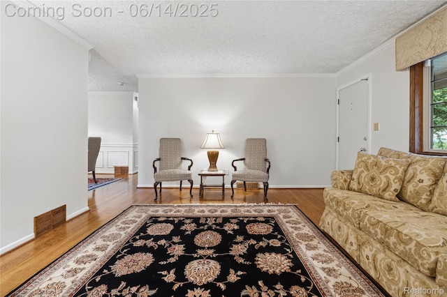 5614 Warbler Dr, Clarkston, MI 48346 - living area with wood finished floors, a textured ceiling, and crown molding