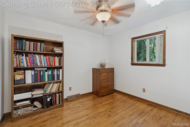 5614 Warbler Dr, Clarkston, MI 48346 - sitting room featuring wood finished floors, a textured ceiling, and ceiling fan
