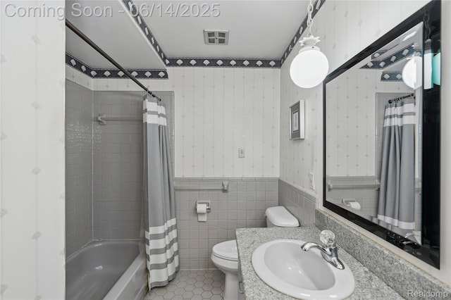 5614 Warbler Dr, Clarkston, MI 48346 - full bath with wallpapered walls, shower / bath combo with shower curtain, vanity, tile walls, and tile patterned floors